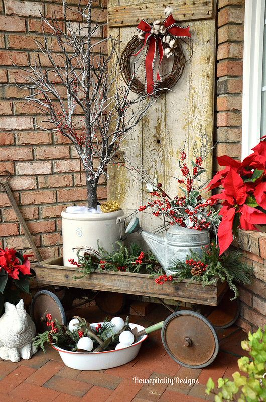 vintage cart with watering cans, pots and evergreens
