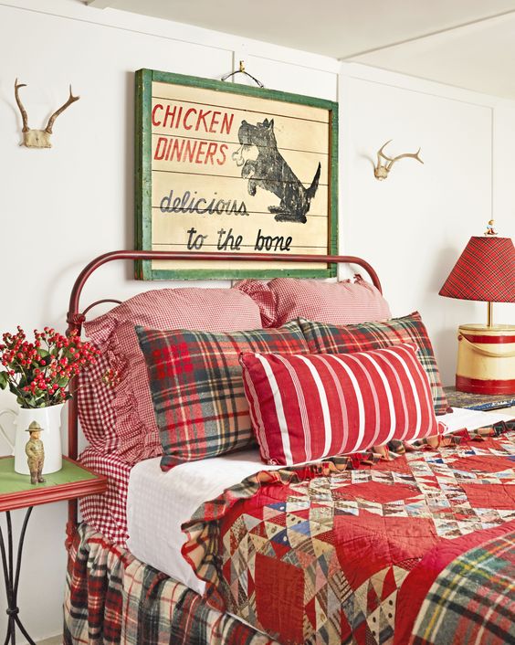 vintage Christmas bedroom decor with red bedding, berries and a pallet sign