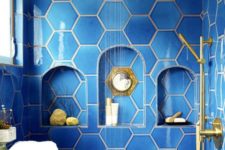 34 bold blue hexagon tiles with niches in the shower