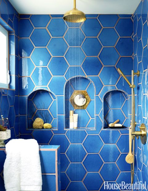bold blue hexagon tiles with niches in the shower