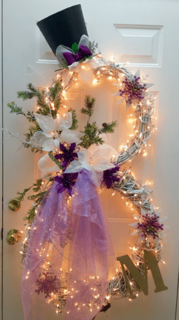 lit up snowman wreath with a monogram and tulle