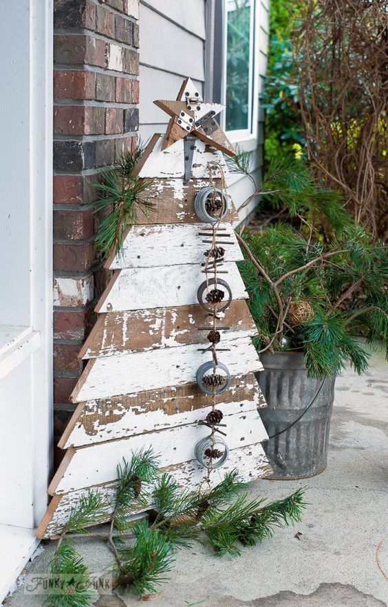shabby chic pallet tree with a garland of jar lids, pinecones and sticks