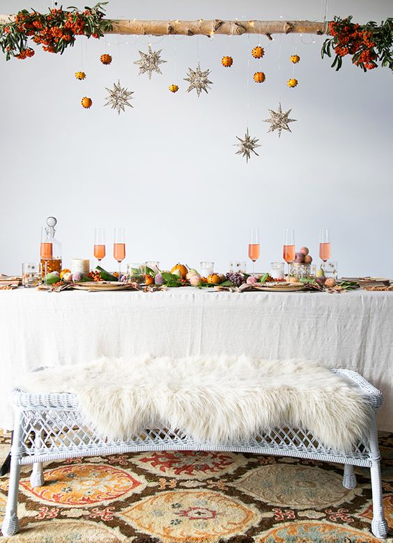 a wooden branch with glitter stars and pomanders, fur bench covers