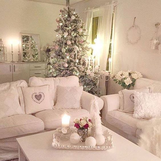 shabby chic pink and ivory living room with a large tree in the same shades