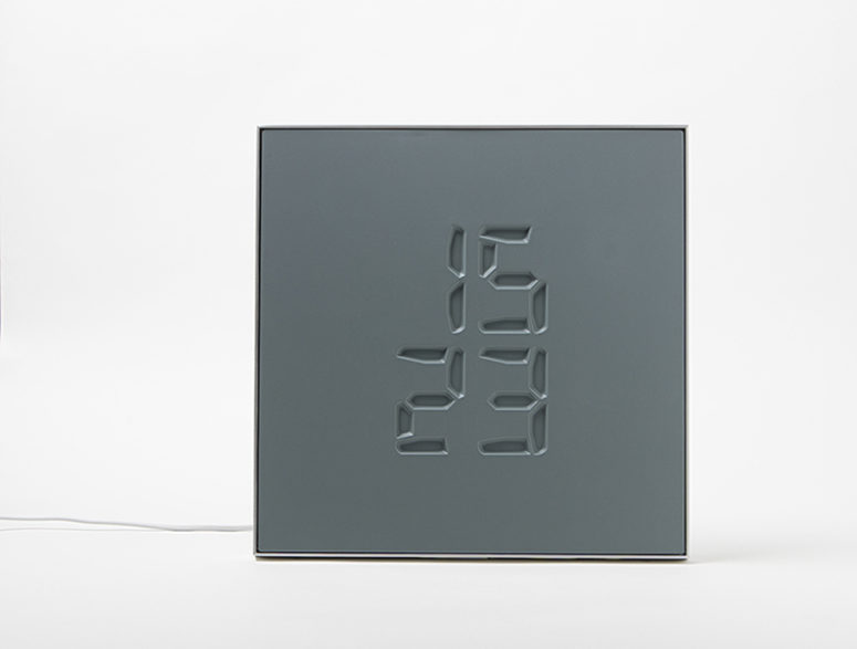 Etch clock engraves time on its surface