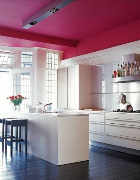 a fuchsia ceiling in this pure white kitchen looks very eye-catching and girlish