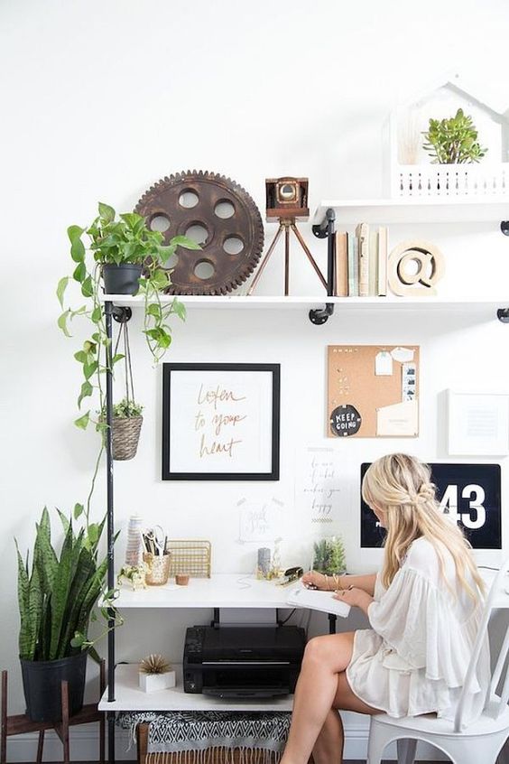 Scandinavian inspired workspace is enlivened with potted greenery