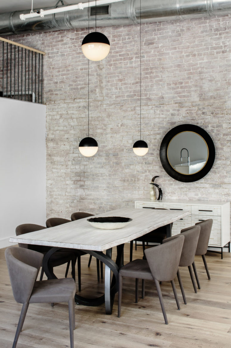The whole space features an amazing whitewashed brick wall, and there's a whitewashed wooden dining table that echoes