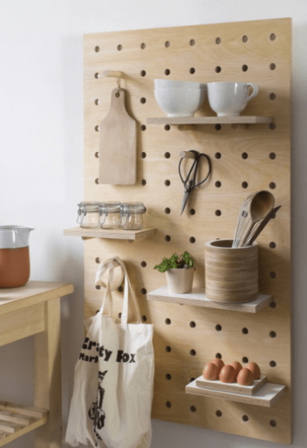 Light colored wooden pegboard with shelves will fit a modern or minimalist kitchen
