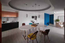 04 In the center of the apartment there’s a dining zone accentuated with a ceiling and pendant lamps