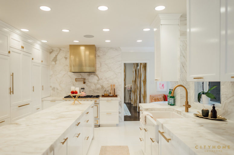 The kitchen is totally clad with marble and spruced up with shiny brass touches and lots of lights