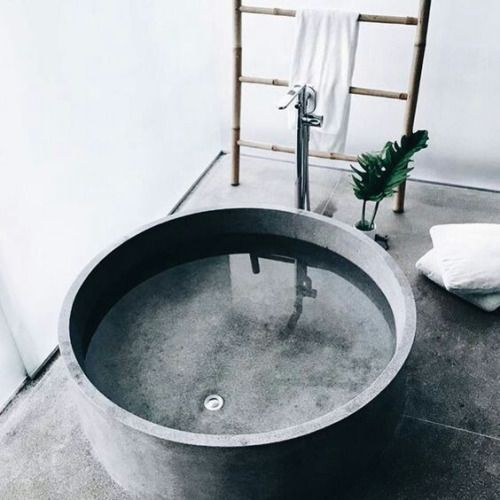 round concrete bathtub has a luxury feel