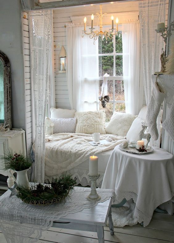 Shabby chic all white window nook with soft pillows