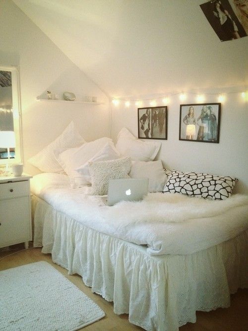 clean and airy white dorm room design with lights