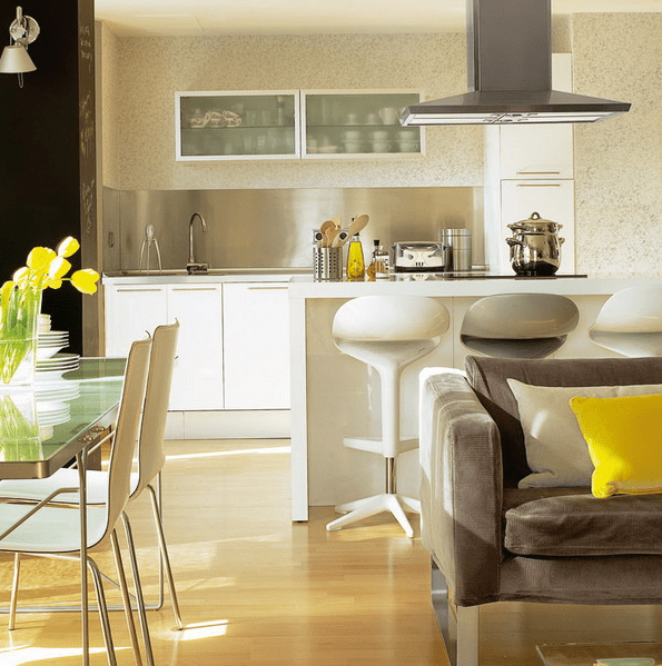 every space is separated with its furniture - sofas, tables and a kitchen island