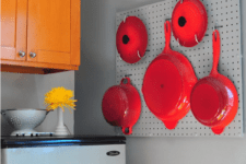 05 metal pegboard with hot red pans and frying pans looks like a decoration