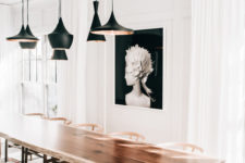 06 A composition of hanging black lamps and a dark artwork accentuate the subtle shade space