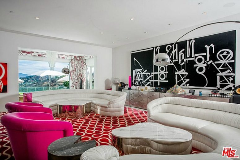 The decor of this room is much bolder, with red and hot pink accents