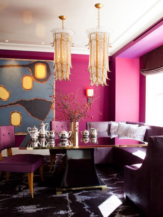 refined dining space with fuchsia walls, unique gold chandeliers and purple furniture