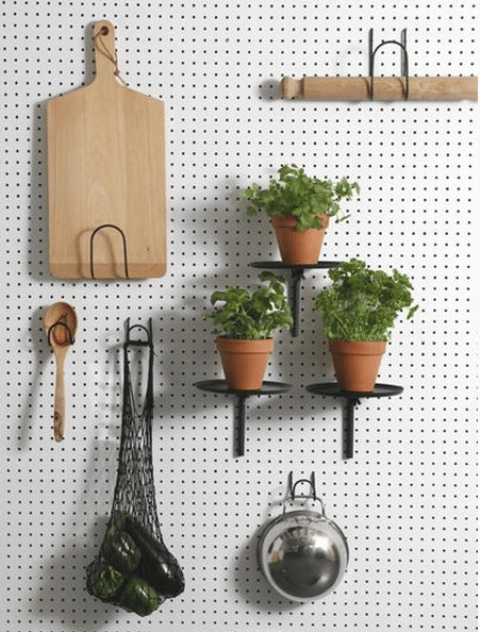 white pegboard with black shelves and hooks looks modern
