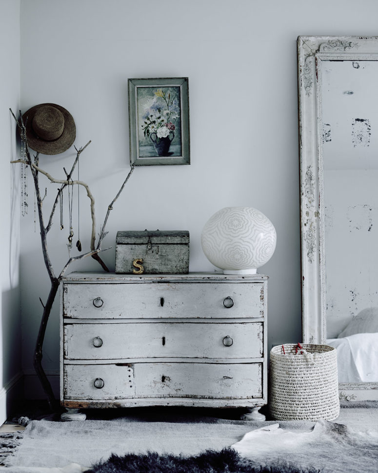 The bedroom is shabby and whitewashed, with a sideboard and an oversized mirror, textiles and crochets