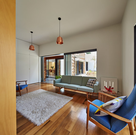 The living room has mid-century modenr features, it's rather cozy and filled with light
