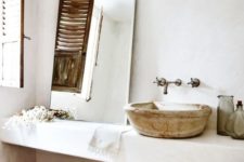 07 The master bathroom reminds of some Moroccan space due to the antique sink and woven baskets