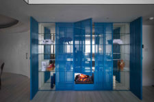 07 There’s a bold blue sheer storage unit with a built in fireplace, such an interesting solution