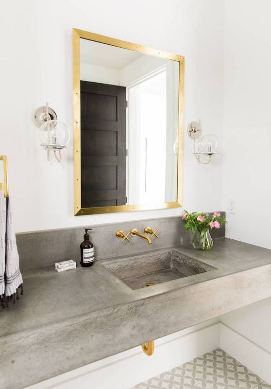 concrete sink and countertop look contrasting with gold touches