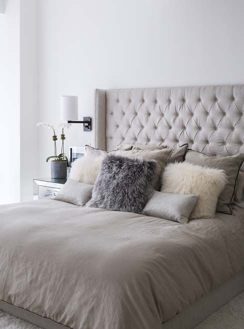 taupe-colored upholstered bed with taupe pillows looks very inviting yet neutral
