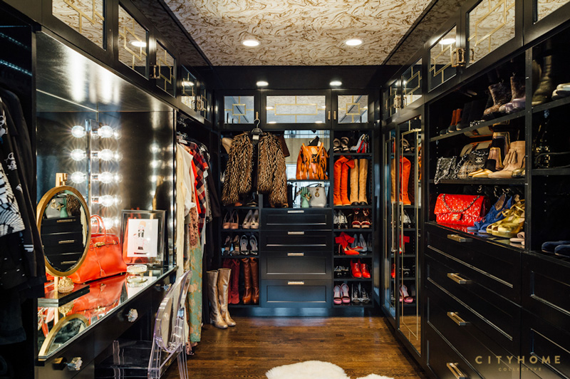 The closet is dark, and colorful clothes and accessories of the owners make it bolder