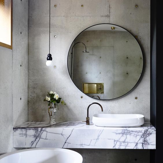 concrete walls and marble countertops look very unusual and cool together