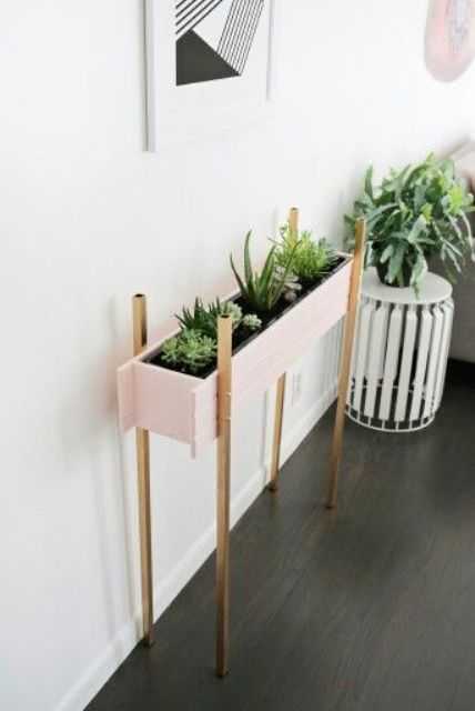 such a stylish blush planter on metallic legs can accentuate the room
