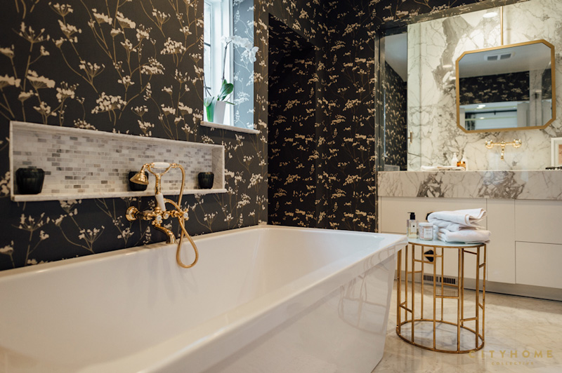 The master bathroom has a touch of mid century, with brass and copper details and marble