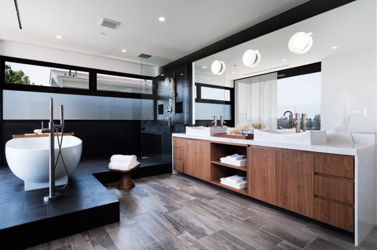 The master bathroom is done in warm woods and black tiles, looks very chic and laconic