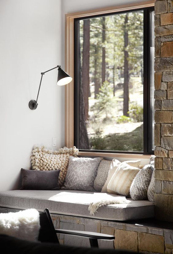 cozy window seat with pillows for reading there