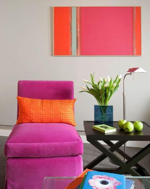 fuchsia lounge chair and an artwork that echoes with it