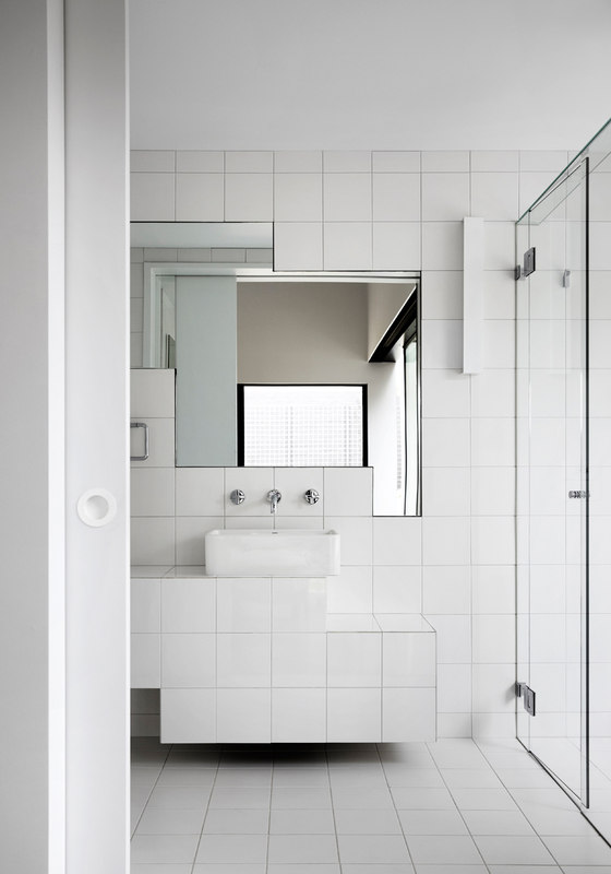 The bathroom is modern and chic, I love the geometry of mirrors here, they create a simple yet eye catching accent