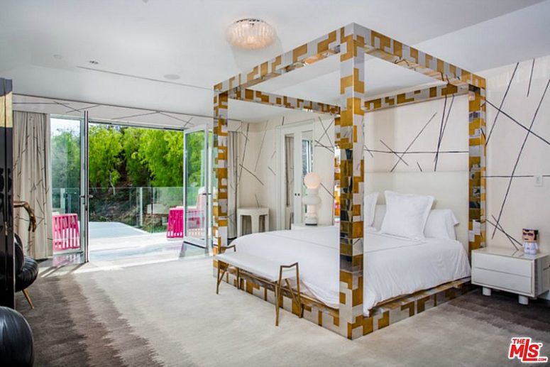 The bed is a focal point in this bedroom, it's done in silver and gold geometric patterns