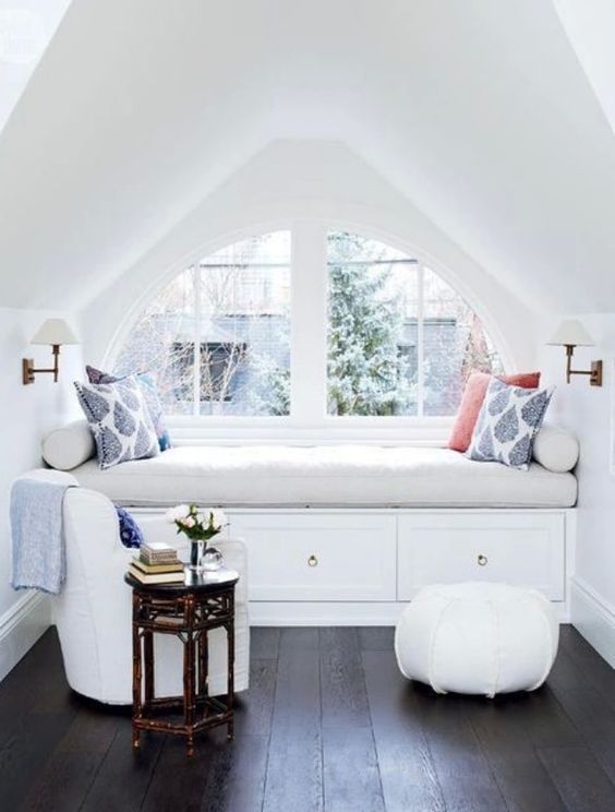 all-white window sill nook is a great place to spend time in the winter