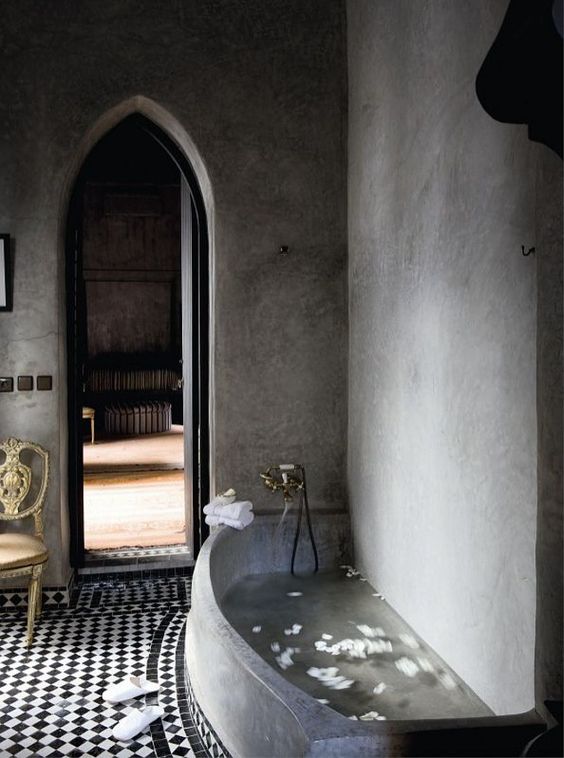 concrete bathtub in a Moroccan-styled bathroom