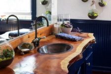 10 navy bathroom with succulent terrariums is made cozier with a raw wood edge countertop