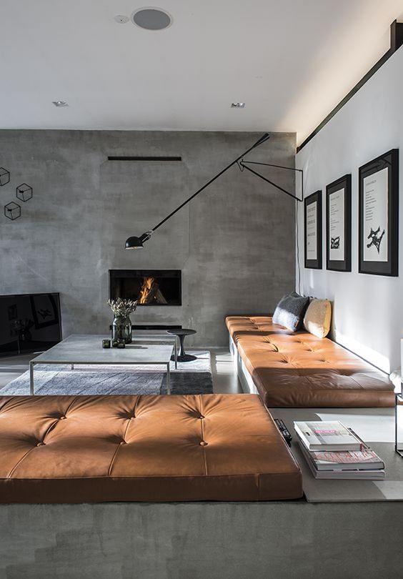 chic masculine living room with a concrete wall and copper leather