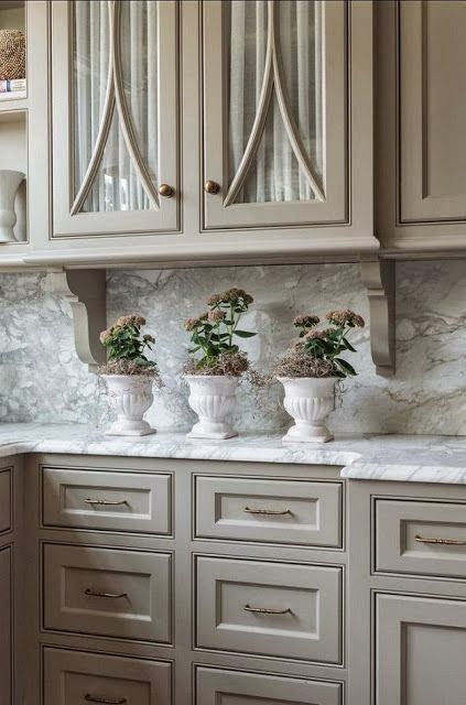 Classic kitchen with taupe cabinets and marble surfaces looks refined
