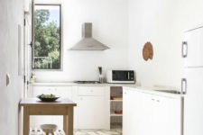 12 A window allows plenty of natural light in lighting up the white kitchen beautifully