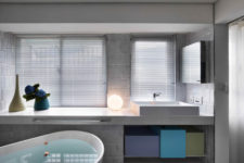 12 Master bathroom is clean and simple, with colorful geometric boxes for storage