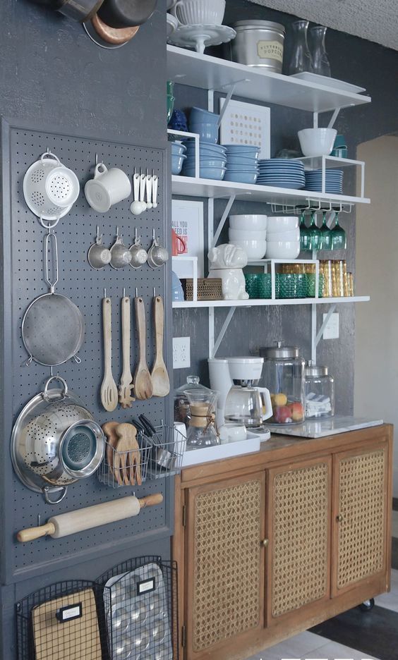 dark grey wall storage with utensils and cooking stuff