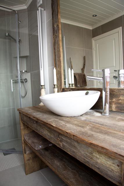  a modern bathroom with a countertop and mirror frame from recycled materials