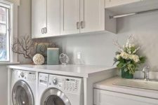 13 cabinets all over the laundry is a grey way to keep it uncluttered, keep them light-colored to visually expand the space