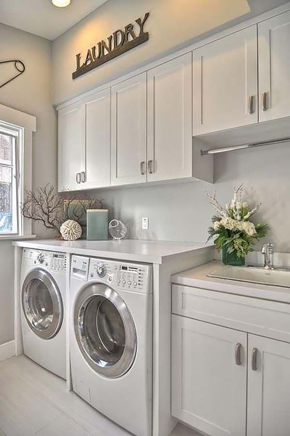 cabinets all over the laundry is a grey way to keep it uncluttered, keep them light-colored to visually expand the space
